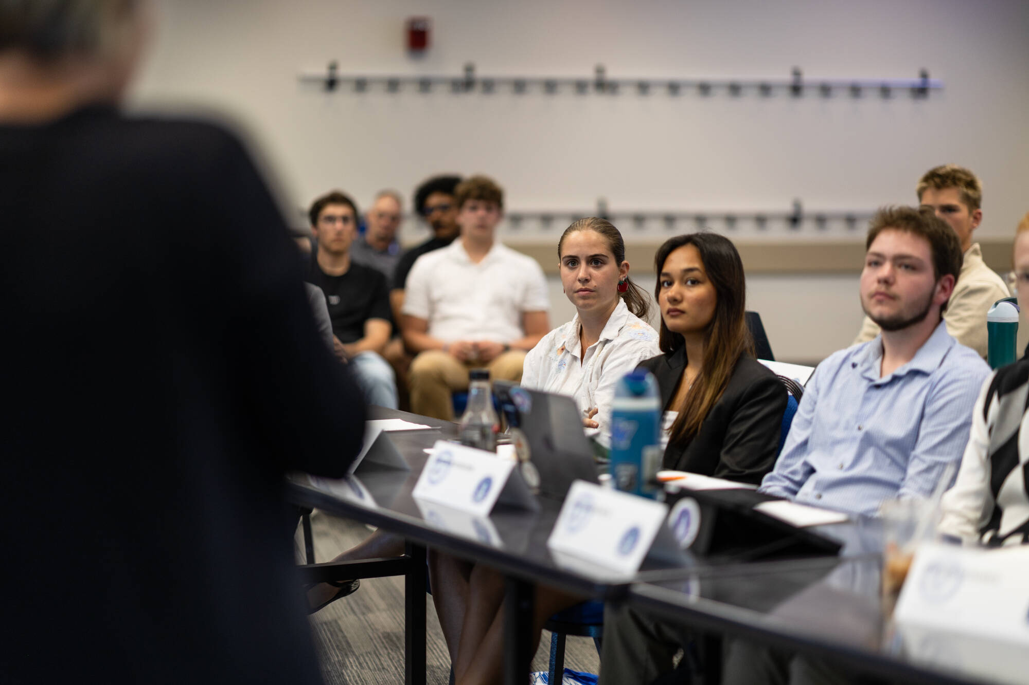 Three student senators sitting at a tabling during general assembly.